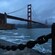 The Golden Gate Bridge in San Francisco, California, at dusk under a cloudy sky
